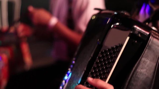 An extremely closeup of an accordionist playing accordion during a cultural music event in Brazil, Rio de Janeiro
