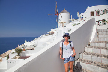 Obraz premium beautiful Oia town on Santorini island, Greece. Traditional white architecture and greek orthodox churches with blue domes over the Caldera, Aegean sea. Scenic travel background
