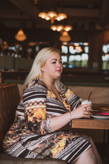 Simple plump woman at city. Lady in cafe rest and enjoy 