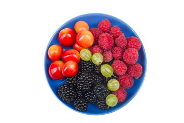 Various summer Fresh berries in a bowl on rustic wooden table. .Antioxidants, detox diet, organic fruits. Top view