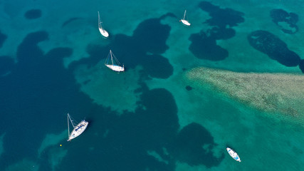 Obraz premium Aerial drone bird's eye top view photo of traditional fishing boats in island of Mykonos, Cyclades, Greece