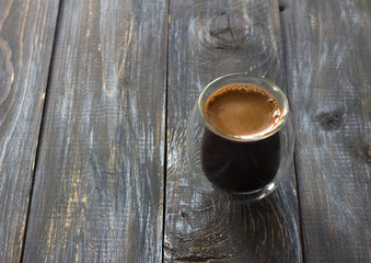 Double wall coffee cup on a wooden background, aged surface, hot cup of coffee