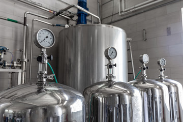 Manometers on steel cylinder storages or vats or tanks on production plant, industry equipment