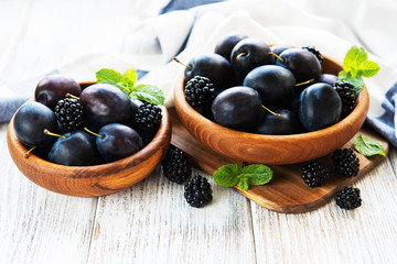 Bowls with fresh plums
