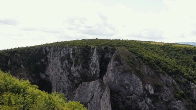 View Of The Stunning Cheile Turzii Gorge - Overlooking The Far Distance Mountain Chain. Camera Panning To The Right.