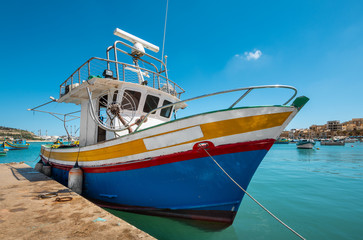 Naklejka na ściany i meble Marsaxlokk, Malta - Colourful fishing boats in Marsaxlokk