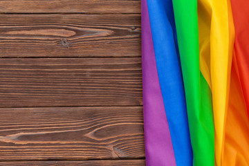 Rainbow lgbt flag on wooden table shot in studio
