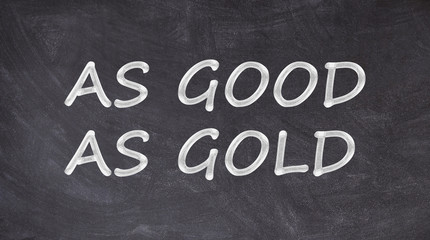 Obraz premium As good as gold written on blackboard