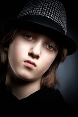 Portrait of a Boy with Blond Hair in Hat and Black Top.