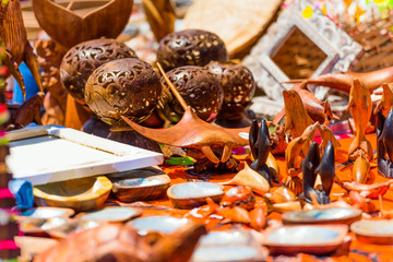 Carved wooden souvenirs in the local market, Rarotonga, Aitutaki, Cook Islands. With selective focus.