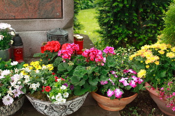 Many coloured flowers before a fresh grave