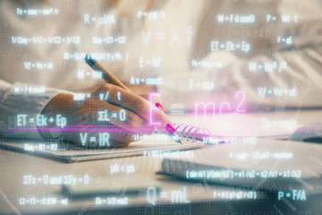 Science formula hologram over woman's hands taking notes background. Concept of study. Multi exposure