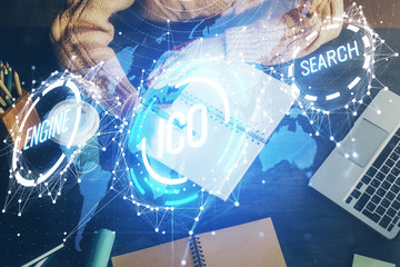 Cryptocurrency hologram over hands taking notes background. Concept of blockchain. Multi exposure