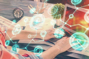 Media network theme hologram with man working on computer on background. Concept of internet communication. Double exposure.