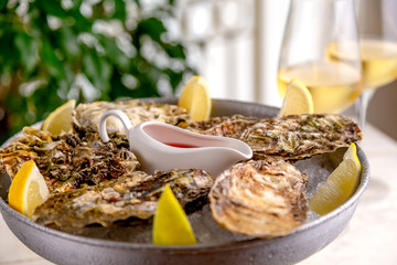 Fresh oysters with ice and white wine. Seafood. White background