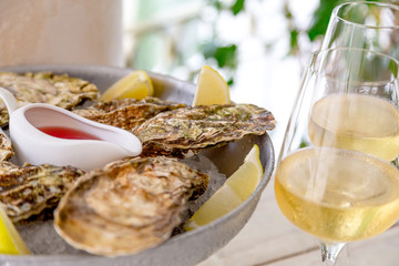 Fresh oysters with ice and white wine. Seafood. White background