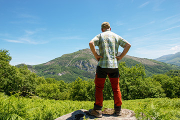 back view of hiker man watching mountains