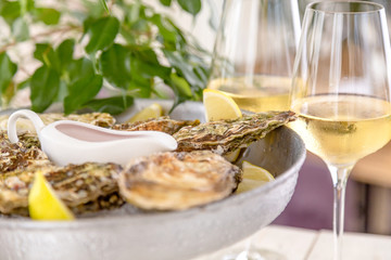 Fresh oysters with ice and white wine. Seafood. White background