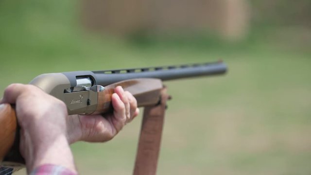 Modern rifle shooting and cartridge case flying out breaching lock in slo-mo 
