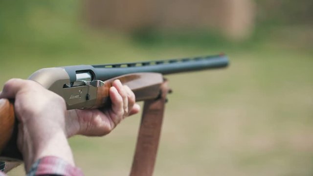 Hunting rifle firing and a cartridge case flying out breaching lock in slo-mo 