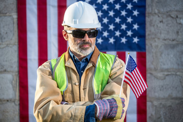 A serious worker man and american flag