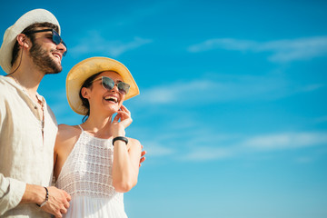 Young beautiful tourist couple enjoying summer holiday on the seaside