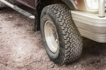 Close up dirty off-road car wheel.
