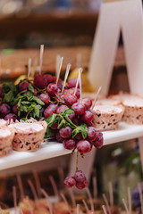 sweet festive buffet, fruit, caps, macaroni and lots of sweets