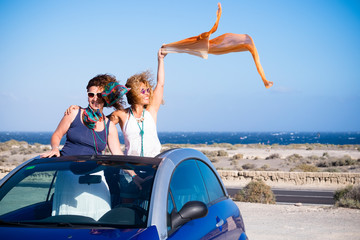 Happy free people on travel vacation - couple of caucasian friends women enjoy the summer holiday...
