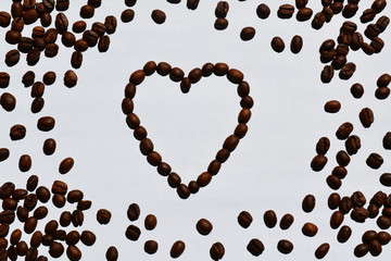 heart of coffee beans on white background