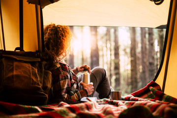 Travel and relax destination people concept - blonde curly woman lay down inside the tent with...