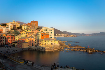GENOA, ITALY, MARCH 23, 2019 - View of Genoa Boccadasse at sunset,  a fishing village with colorful houses in Genoa, Italy.