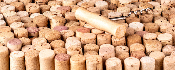 The Corkscrew and wine cork as background