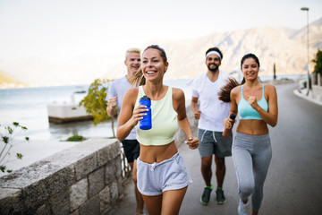 Obraz premium Group of young people jogging and running outdoors in nature