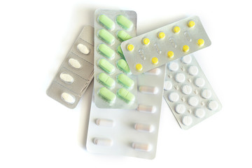 Different medicines: tablets, pills in blister pack isolated on white background
