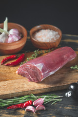 Raw meat in chef hands on black background. Food menu concept.