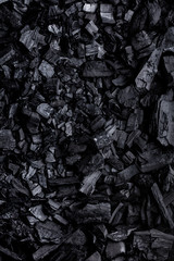 Flat lay of coal mineral black stones background. Coal pattern studio background