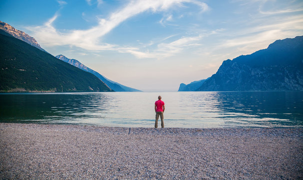 man standing on the edge of Garda lake