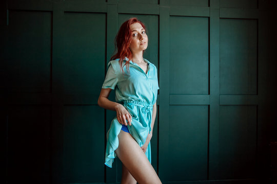Sexy redhead girl in short dress shows leg