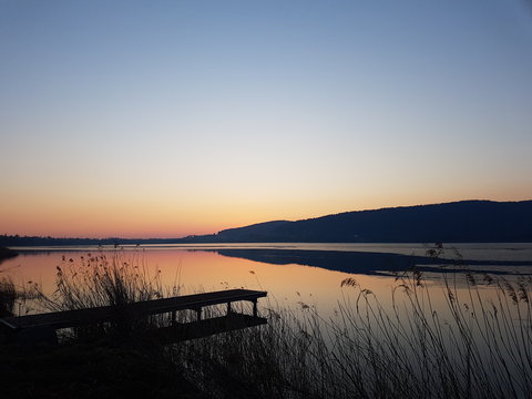 Corgeno lake, Italy - January 20, 2019: golden sunset on the Corgeno lake