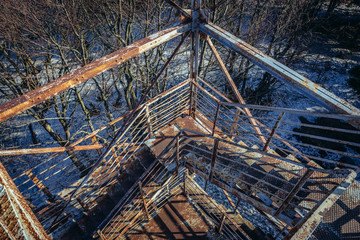 Old rusty observation tower on the peak of Mount Kalenica in Owl Mountains Landscape Park, protected area in Lower Silesia Province of Poland