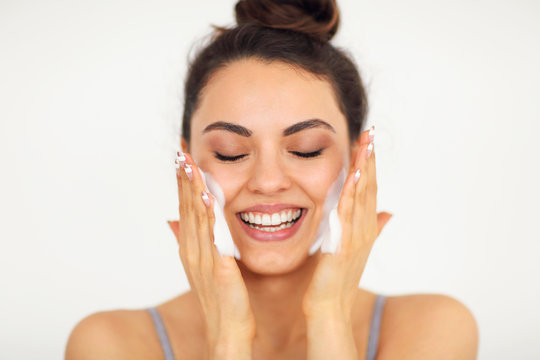 Beautiful Young Caucasian Woman Washing Her Face With Foam