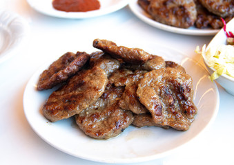 Turkish grilled meatballs on plate.