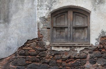 The texture of the old brick. Concrete wall texture with wooden old window.