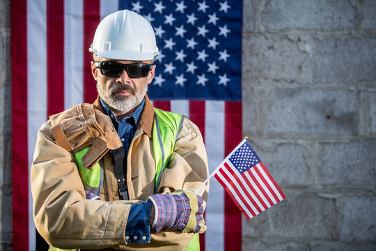 A serious worker man and american flag