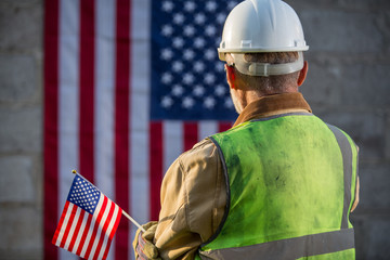 American builder with stars and stripes flag in background