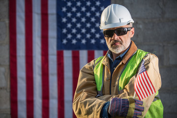 A serious worker man and american flag