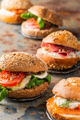 Italian Caprese sandwiches with fresh tomatoes, mozzarella cheese and lamb's lettuce, multigrain bun. Healthy food concept