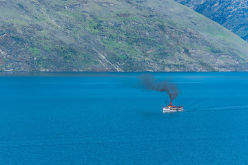 Steamboat sails on lake Wakatipu, Queenstown, New Zealand. Copy space for text.