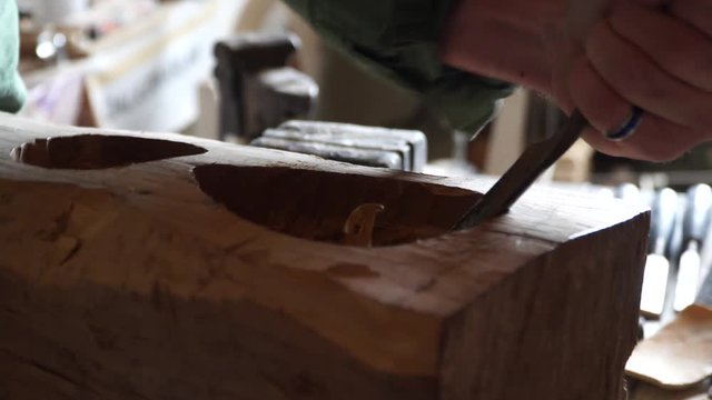 Craftsman making carving with chisel. 4K